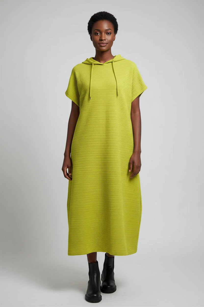 Yellow dress on a hanger against a gray background