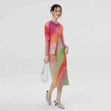 Woman wearing a colorful dress with a plain background