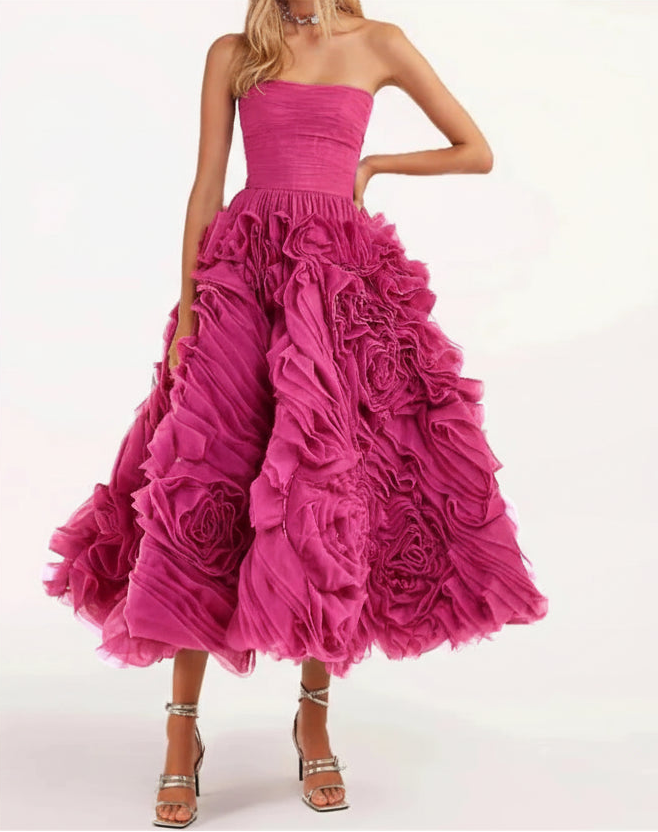 Pink strapless gown with ruffled skirt on a white background