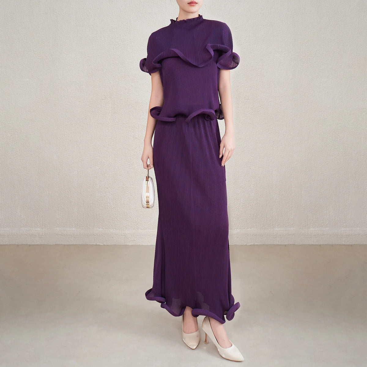Woman wearing a purple outfit with a plain background