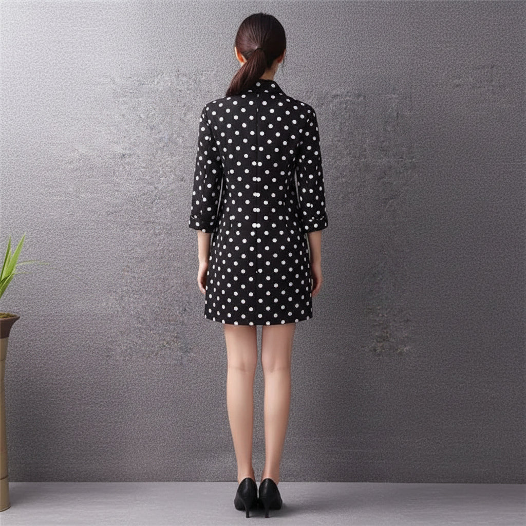 Black shirt with white polka dots on a gray background