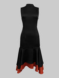 Black dress with a red hem on a gray background