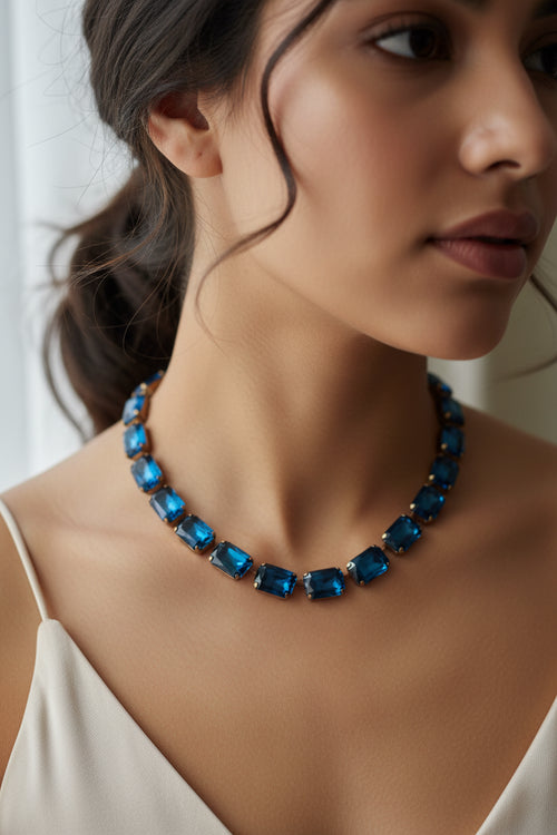 Necklace with blue square beads on a beige background