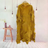 Mustard yellow textured dress on a mannequin against a light background