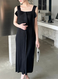 Woman wearing a black dress in an indoor setting