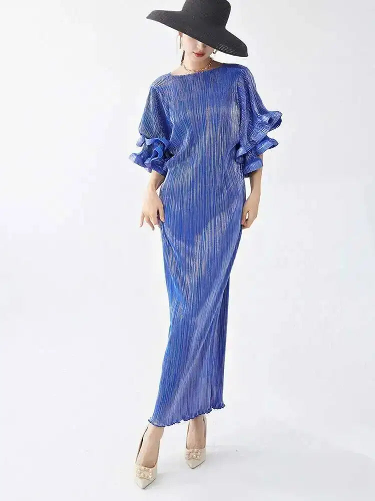 Woman wearing a blue dress with ruffled sleeves on a white background