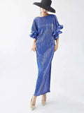 Woman wearing a blue dress with ruffled sleeves on a white background