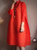 Person wearing a red dress against a brown background
