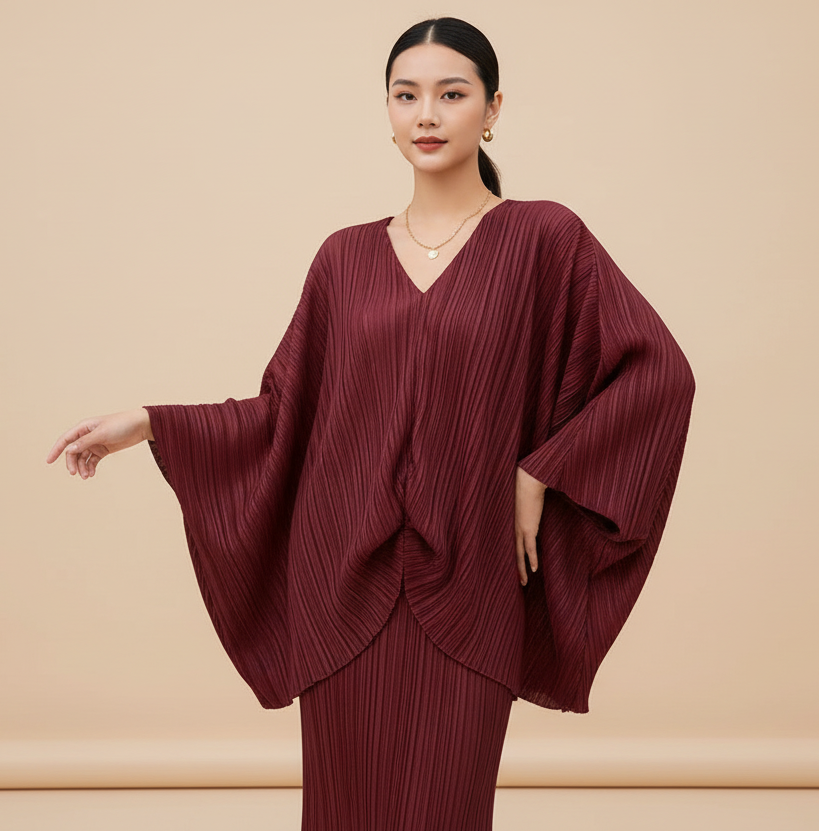 Maroon dress with wide sleeves on a plain background