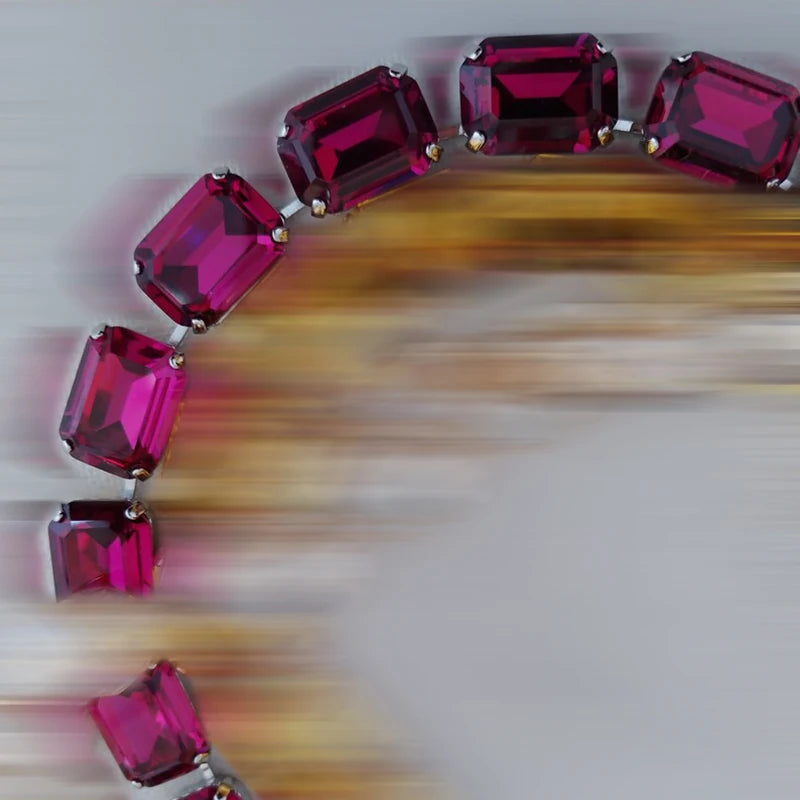 Jewelry with red gemstones on a blurred background