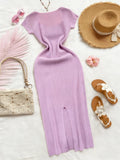 Lavender dress with accessories including a straw hat, sandals, and handbag on a white background