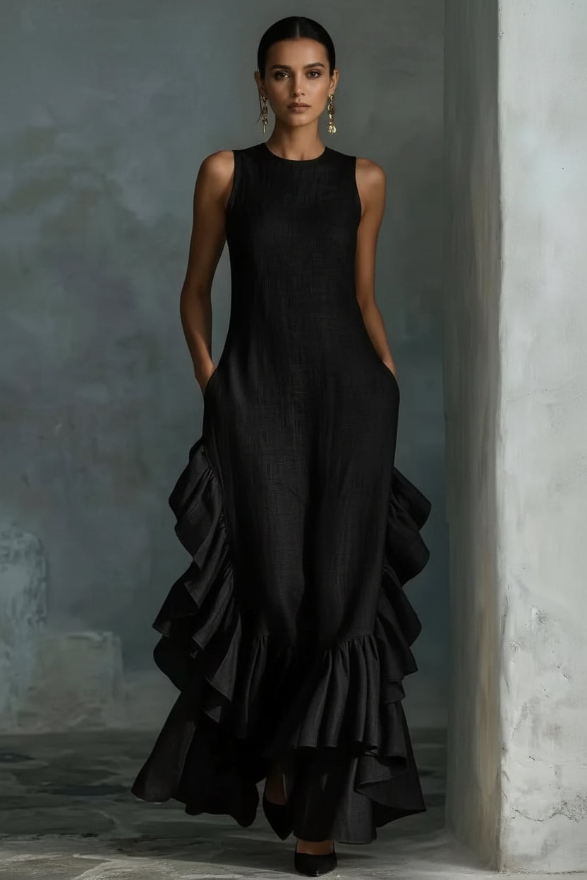 Black ruffled dress worn by a model against a neutral background