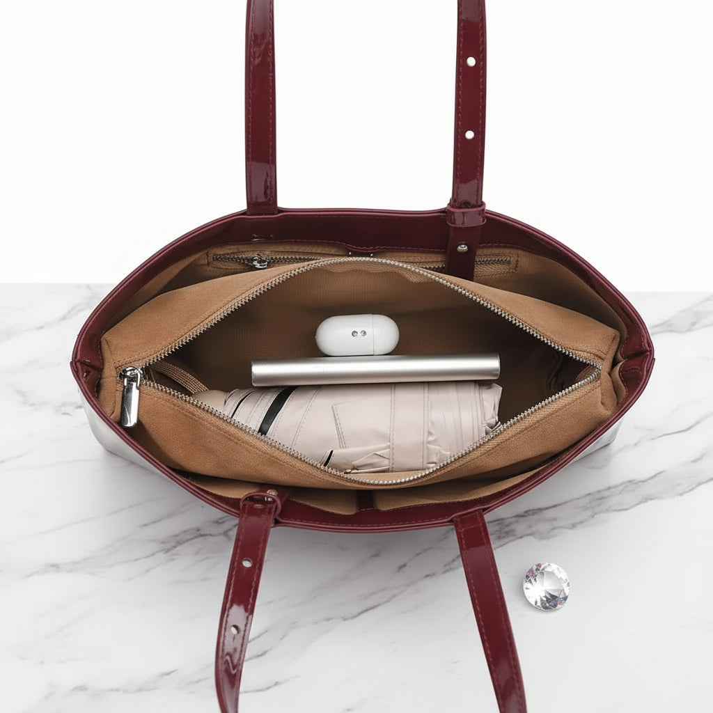 Open red handbag showing its contents on a white background