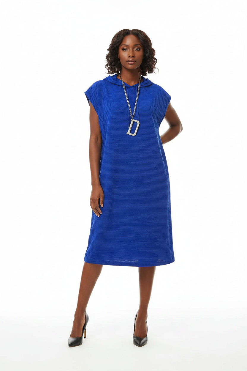 Blue dress on a mannequin with a plant in the background