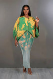 Woman wearing a green and yellow patterned outfit against a gray background