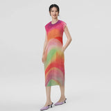 Woman wearing a colorful dress on a plain background