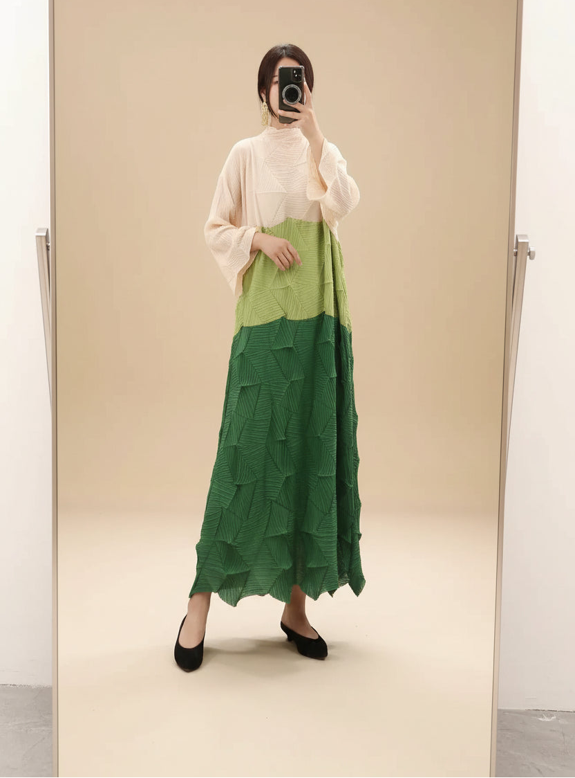 Person wearing a green layered skirt with a plain background