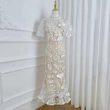 Lace dress on a mannequin against a white curtain