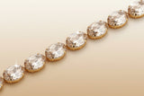 Bracelet with clear gemstones and gold accents on a blurred background