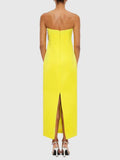 Yellow strapless dress with a high slit on a white background