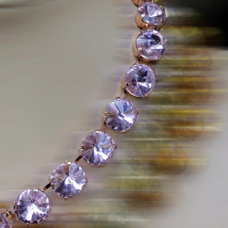 Close-up of a bracelet with pink gemstones on a blurred background