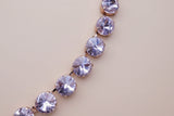 Close-up of a bracelet with pink gemstones on a blurred background