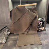 Brown ribbed knit sweater on a hanger with a blurred background
