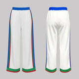 White pants with colorful trim on a gray background