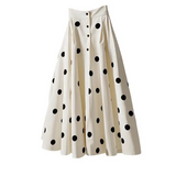 White skirt with black polka dots on a white background